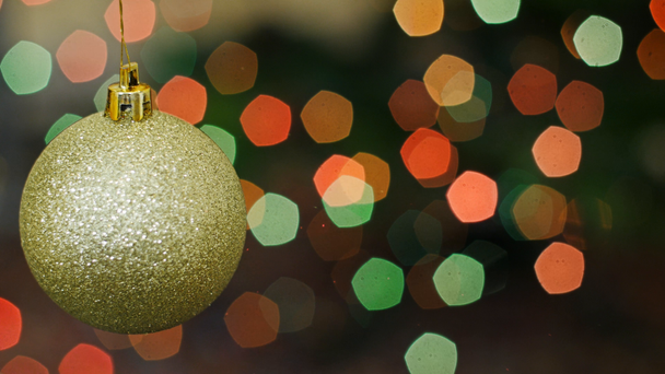 Christmas golden ball rotates at bokeh. Title area - Footage, Video