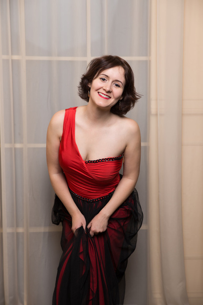 Beautiful young woman wearing a red dress - Foto, Imagem