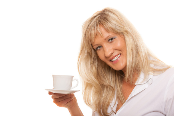 Mature woman drinking tea or coffee.. - Fotografie, Obrázek