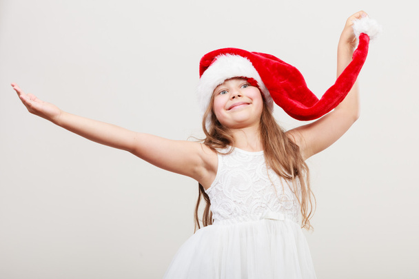 Happy little girl kid in santa hat. Christmas. - Fotó, kép