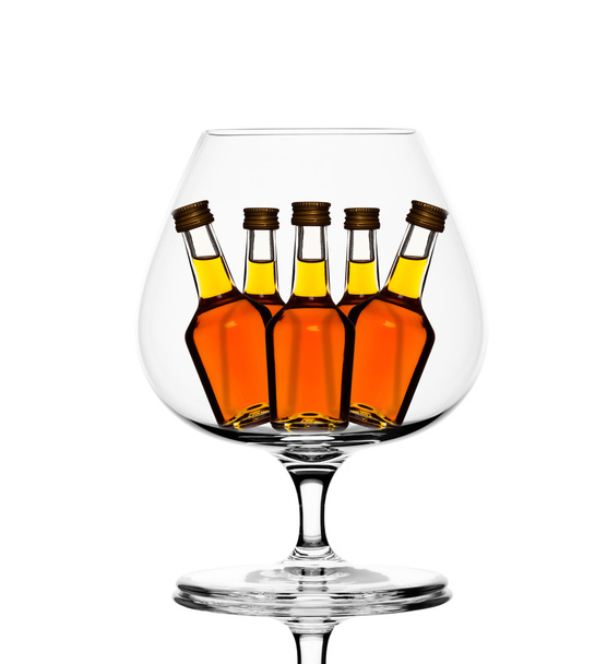 Cognac glass with little cognac bottles inside - Fotografie, Obrázek
