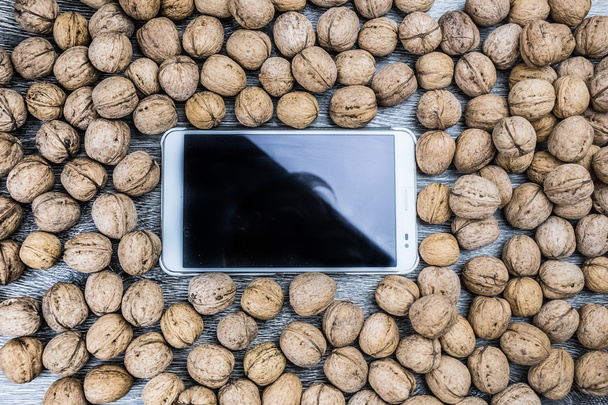Plenty of walnuts with tablet pc - Photo, image
