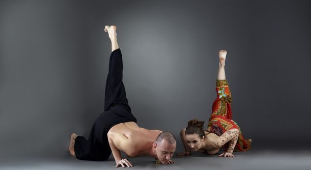 Experienced instructors posing while doing asana - Foto, imagen