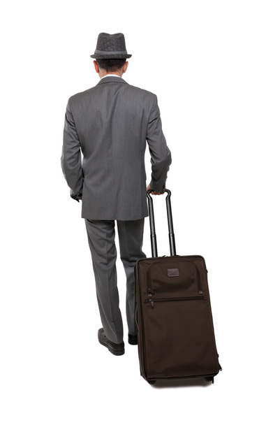 Rear view of one caucasian business traveler man walking with carry-on bag - Zdjęcie, obraz