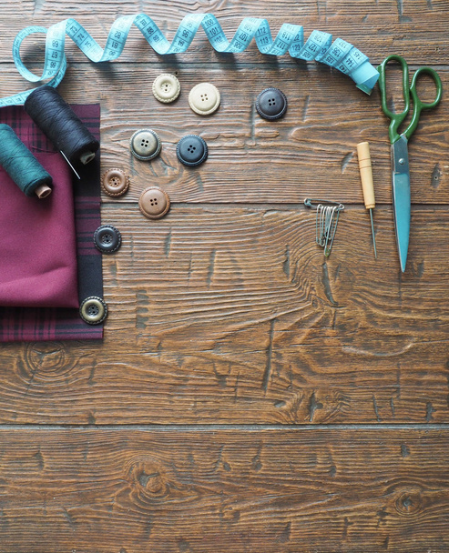 Sewing accessories  in a wood background - Foto, Bild