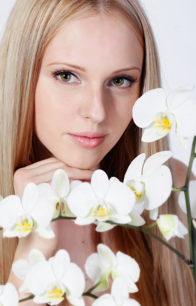 Girl with white orchid - Foto, afbeelding