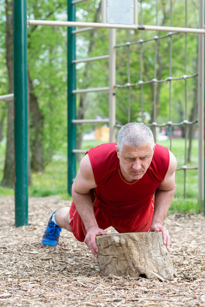Senior Exercising In Sport Park - Foto, Imagen
