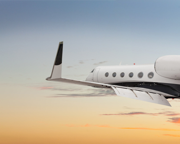 Close side view of a private jet flying - Photo, Image