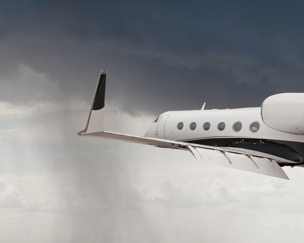 Close side view of a private jet flying - Photo, Image