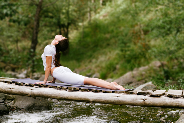 Woman  doing yoga in nature. - 写真・画像