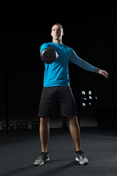 Man doing Kettle bell workout. - Photo, image
