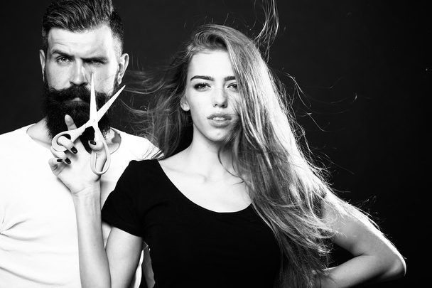 Fashionable couple with scissors - Foto, afbeelding