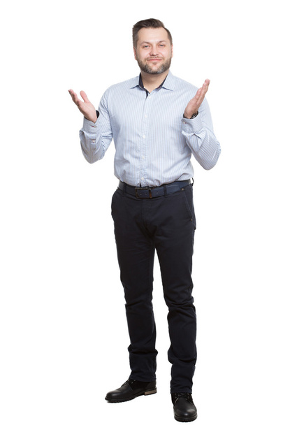 adult male with a beard. isolated on white background. open posture. legs apart. palm upwards. foot forward - 写真・画像