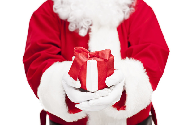 Santa Claus holding a present  - Φωτογραφία, εικόνα