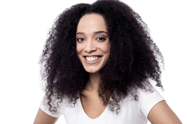 Smiling female model with curly hair - Φωτογραφία, εικόνα