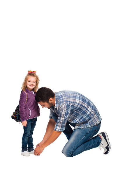 father arranging backpack of his daughter  - 写真・画像