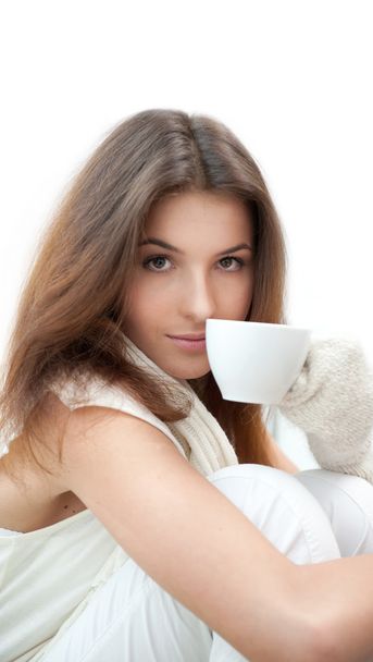 Portrait of a charming woman holding a cup of tea and daydreaming - Photo, image