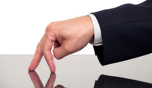Close up of a businessman's fingers walking on a desk - 写真・画像