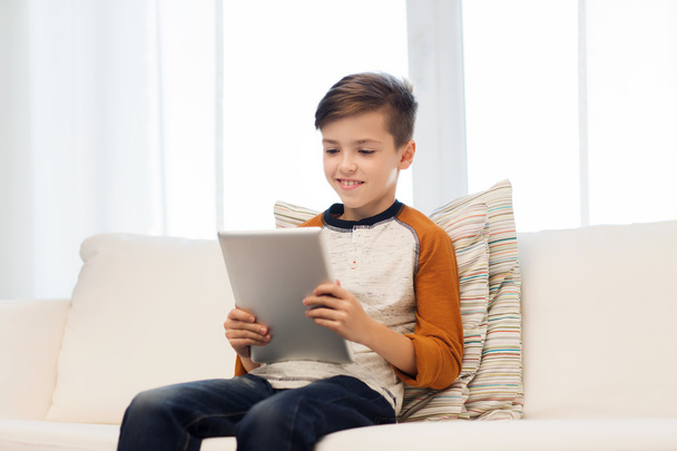 smiling boy with tablet computer at home - Φωτογραφία, εικόνα