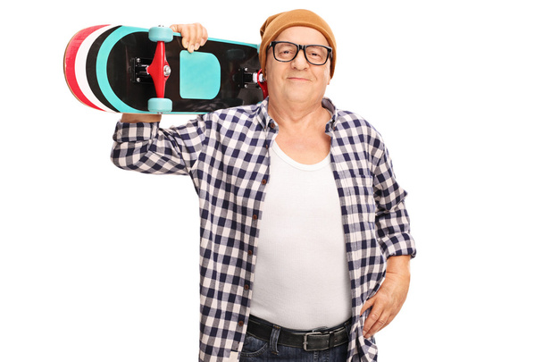 Senior hipster holding a skateboard  - Fotó, kép