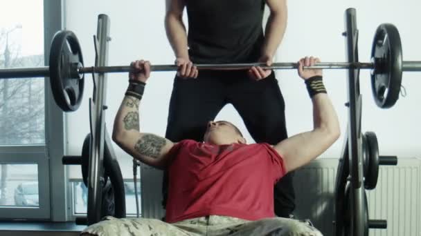 The bodybuilders does exercise with a bar - Footage, Video
