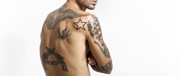 Sexy tattooed man back portrait looking at camera letterbox - Фото, изображение