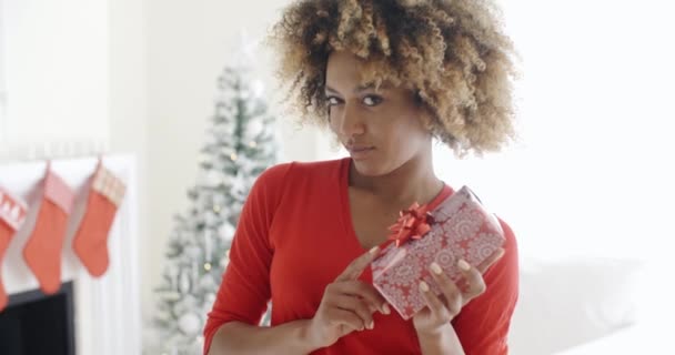 woman shaking Christmas gift - Video