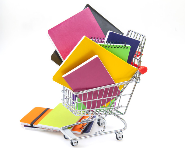 Notebooks of various colors in the cart for shopping - Foto, Bild