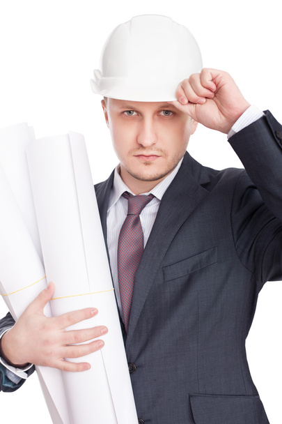 Engineer wearing white hardhat with blueprints isolated on white - 写真・画像