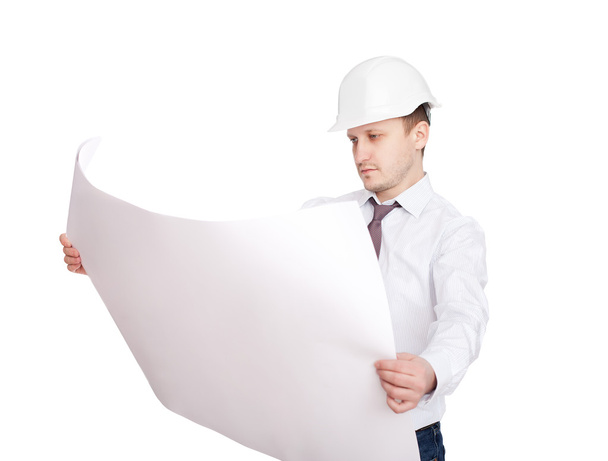 Young engineer looking at blueprint isolated on white background - 写真・画像