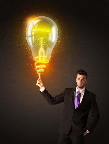 Businessman with an idea bulb - Φωτογραφία, εικόνα