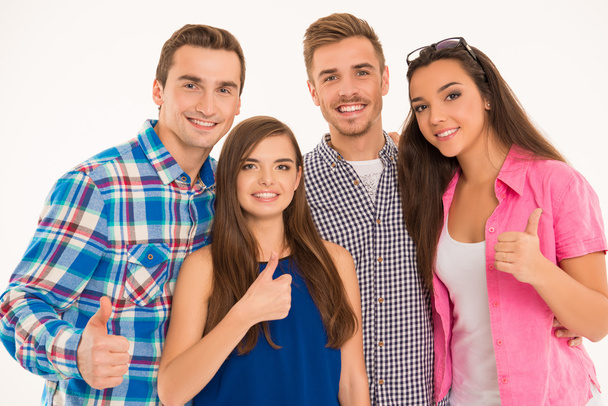 Photo of cheerful young people standing showing thumbs up - Φωτογραφία, εικόνα