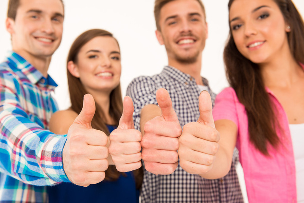 Closeup photo of a happy cheerful  group showing thumbs up - Фото, изображение