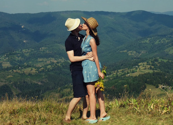 Beautiful young couple hugging and kissing - 写真・画像