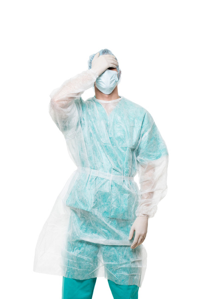 Surgeon portrait. covered face with his hands. sad. isolated on white background - Foto, afbeelding