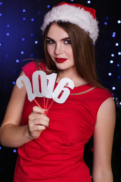 Santa girl is holding paper digits 2016 - Photo, image