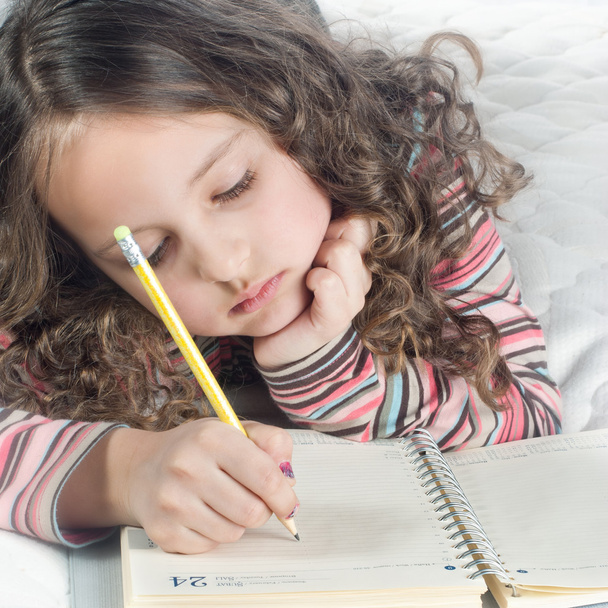 Little girl with notebook and pen - Photo, image