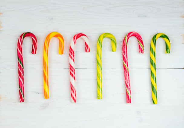 Christmas candy cane on a white wooden background - Foto, Imagem