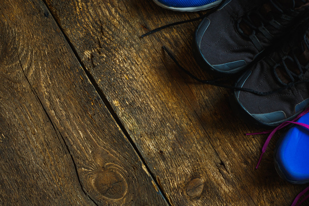 Close up of sneakers on wooden background - Photo, Image