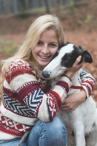Young woman embrace her dog - Foto, afbeelding