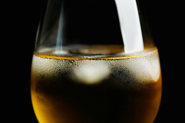 Glass of wine with ice cubes on dark background - Foto, Imagem