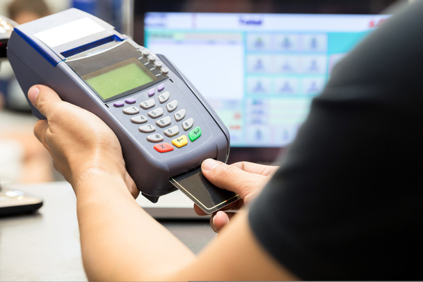 man hand with credit card swipe through terminal for sale in - Foto, Imagen