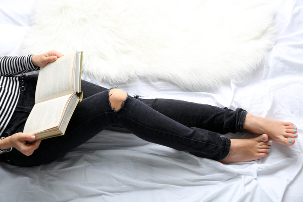 Woman in jeans on bed  - Zdjęcie, obraz