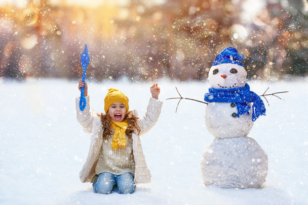 girl playing with a snowman - Photo, image
