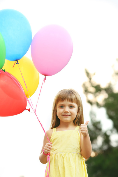 Little girl with balloons   - Фото, зображення