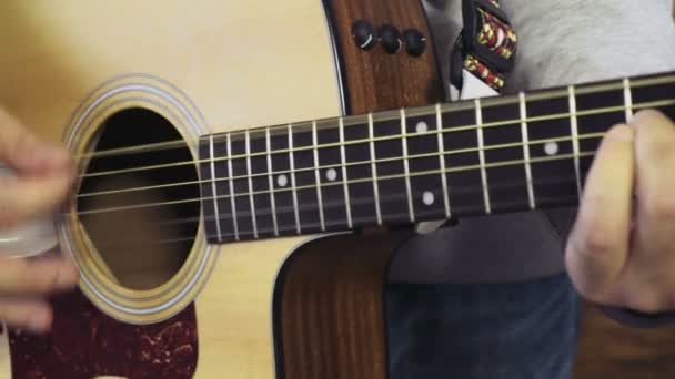 Nahaufnahme eines Mannes, der die akustische Gitarre in Zeitlupe spielt - Filmmaterial, Video