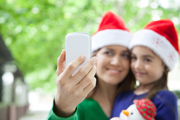 Mother and daughter taking a photo - Foto, imagen