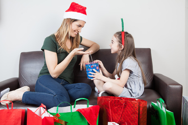 Madre e hija abriendo regalos
 - Foto, imagen