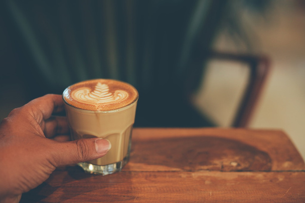 cup of coffee latte on the wood texture  - Fotó, kép