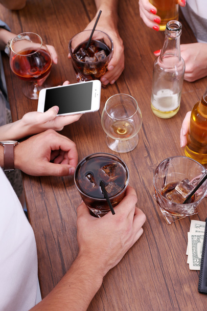 View on friends having alcoholic drinks in the bar, close-up - Photo, Image